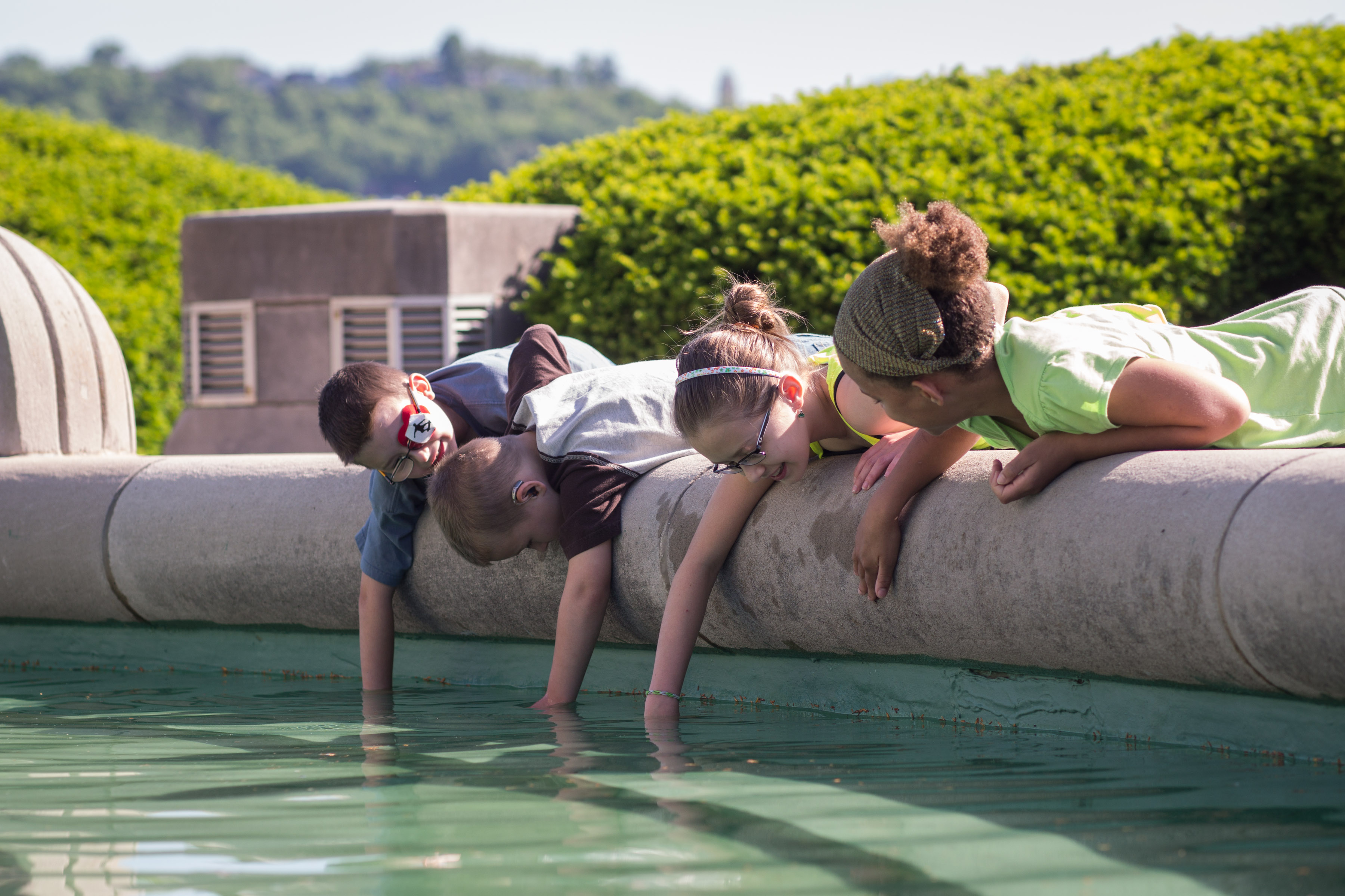 Early childhood home school programs children interacting with the Union Terminal fountain in the summer
