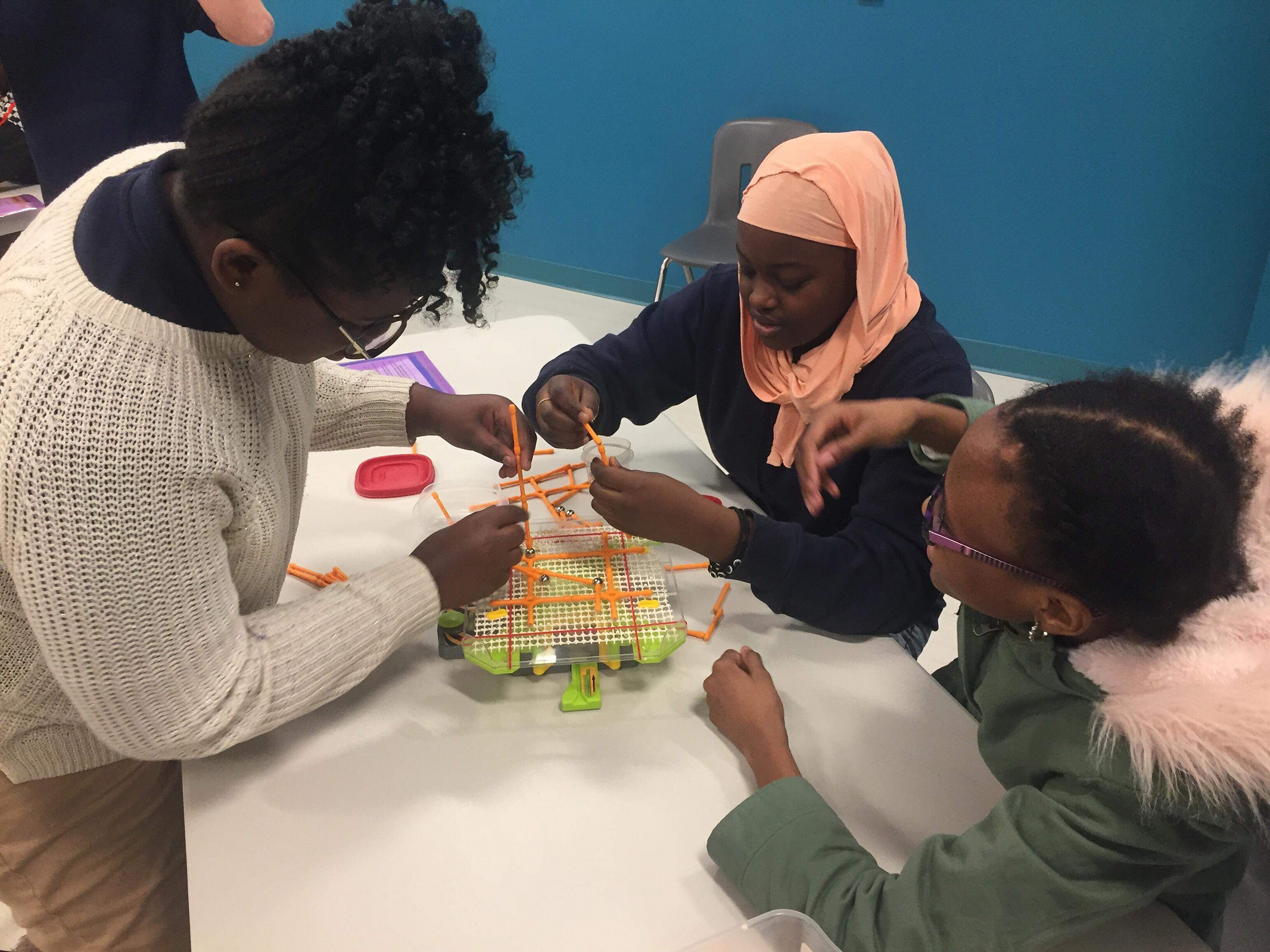 STEM Lab photo of children interacting with a fun and educational activity in the STEM Lab